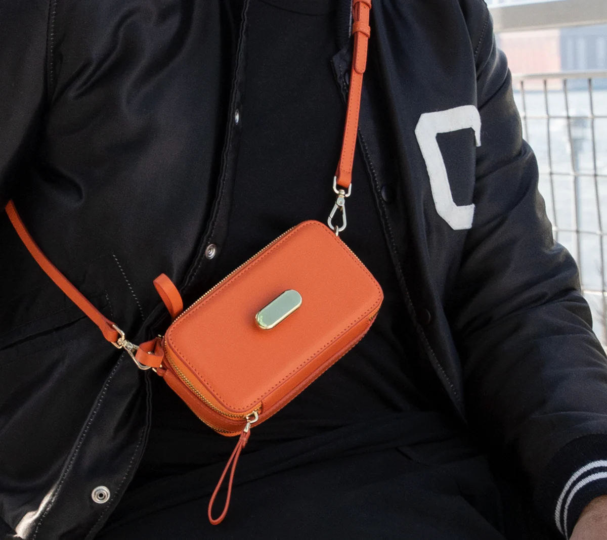 Orange bag shown across the body